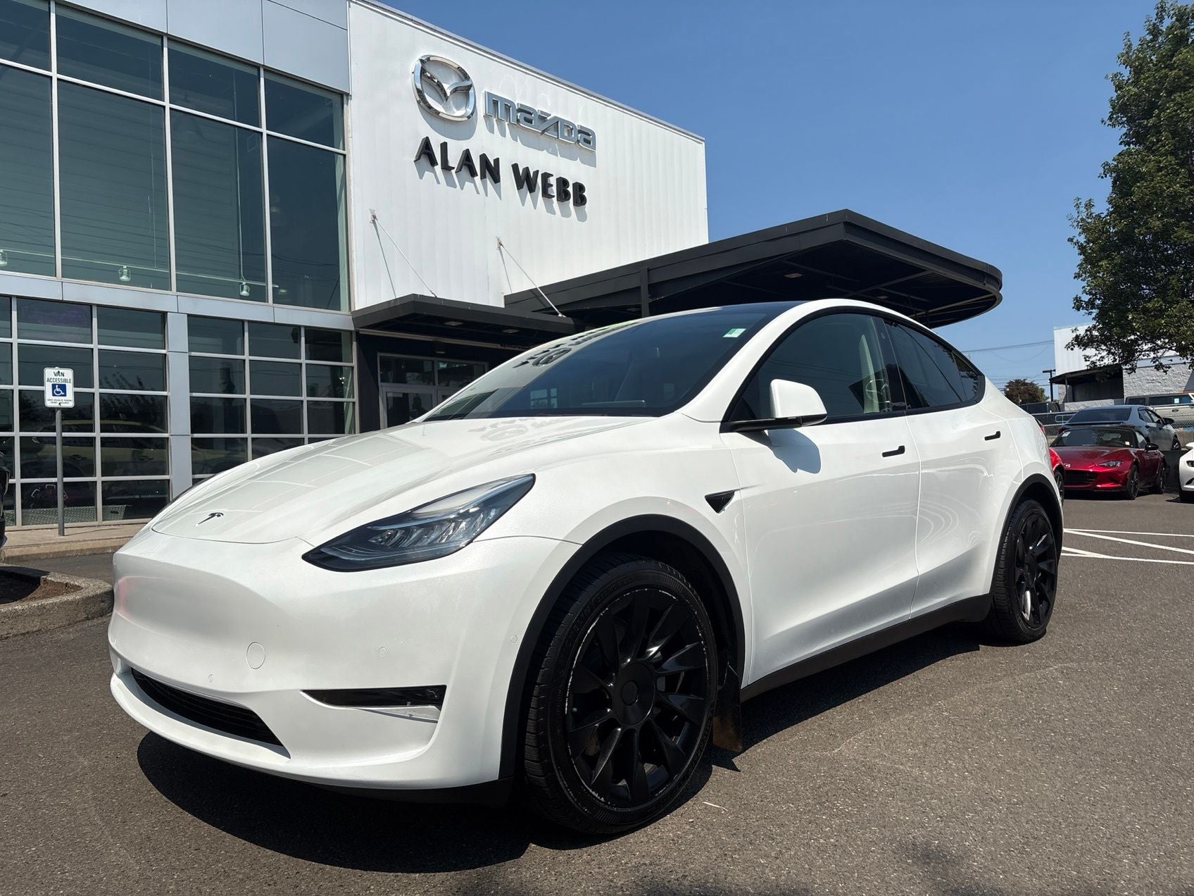 2022 Tesla Model Y Long Range in White — front three-quarter view
